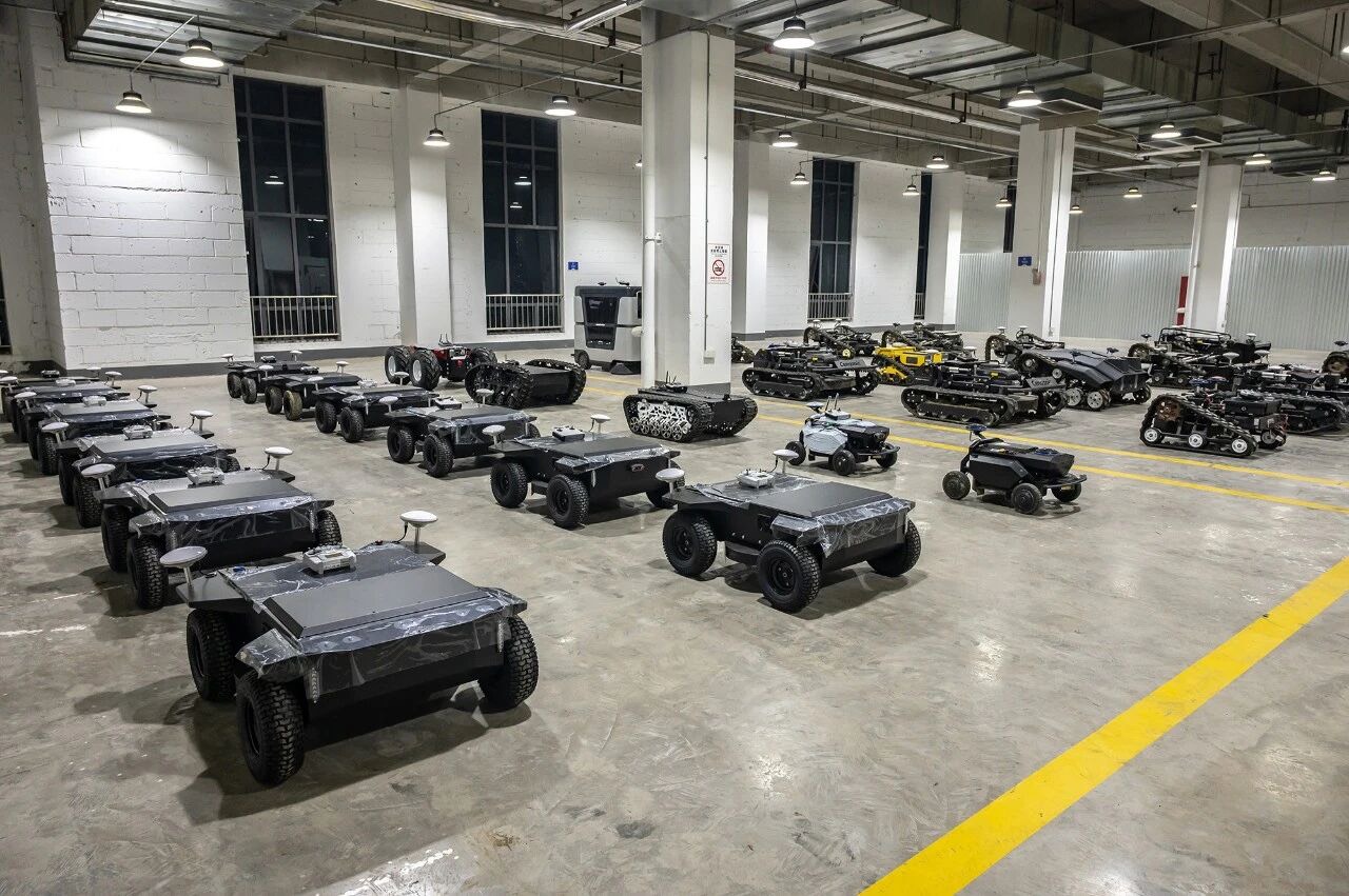 WANJI wheeled and tracked autonomous mowers ready for dispatch in the assembly area