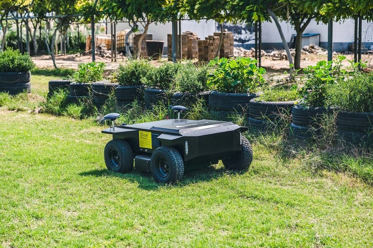 Autonomous electric mower in an orchard area with recycled tire planters