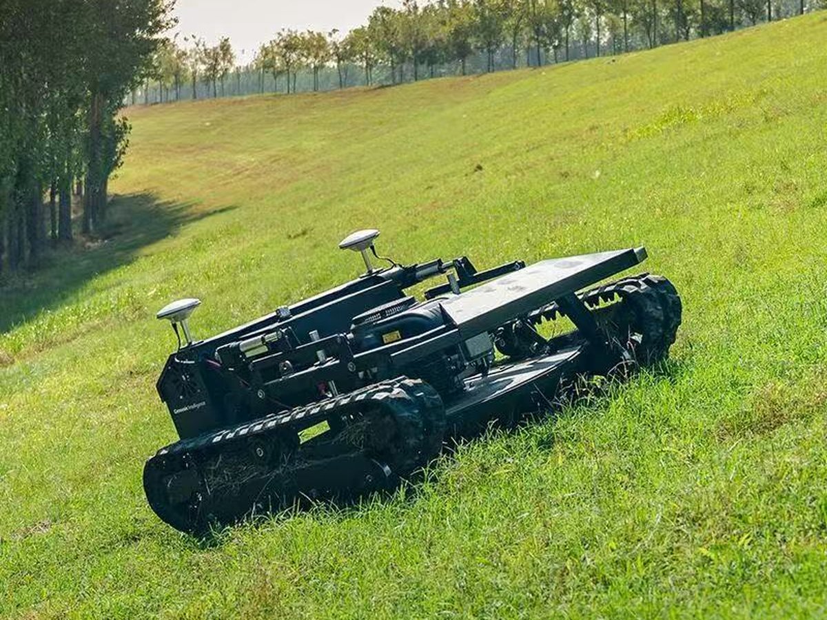 WANJI-T1 tracked hybrid-electric autonomous mower on a sloped grass embankment